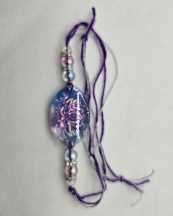 Purple Resin Floral Rakhi with Glitter Finish