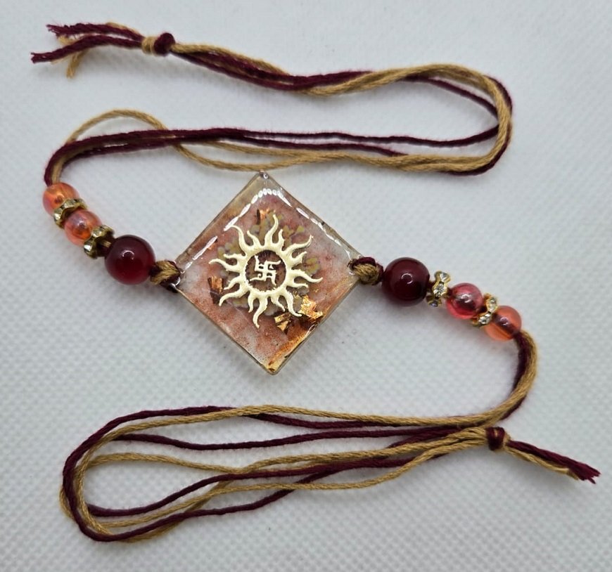 Handcrafted Resin Sun Symbol Rakhi with Swastik Charm